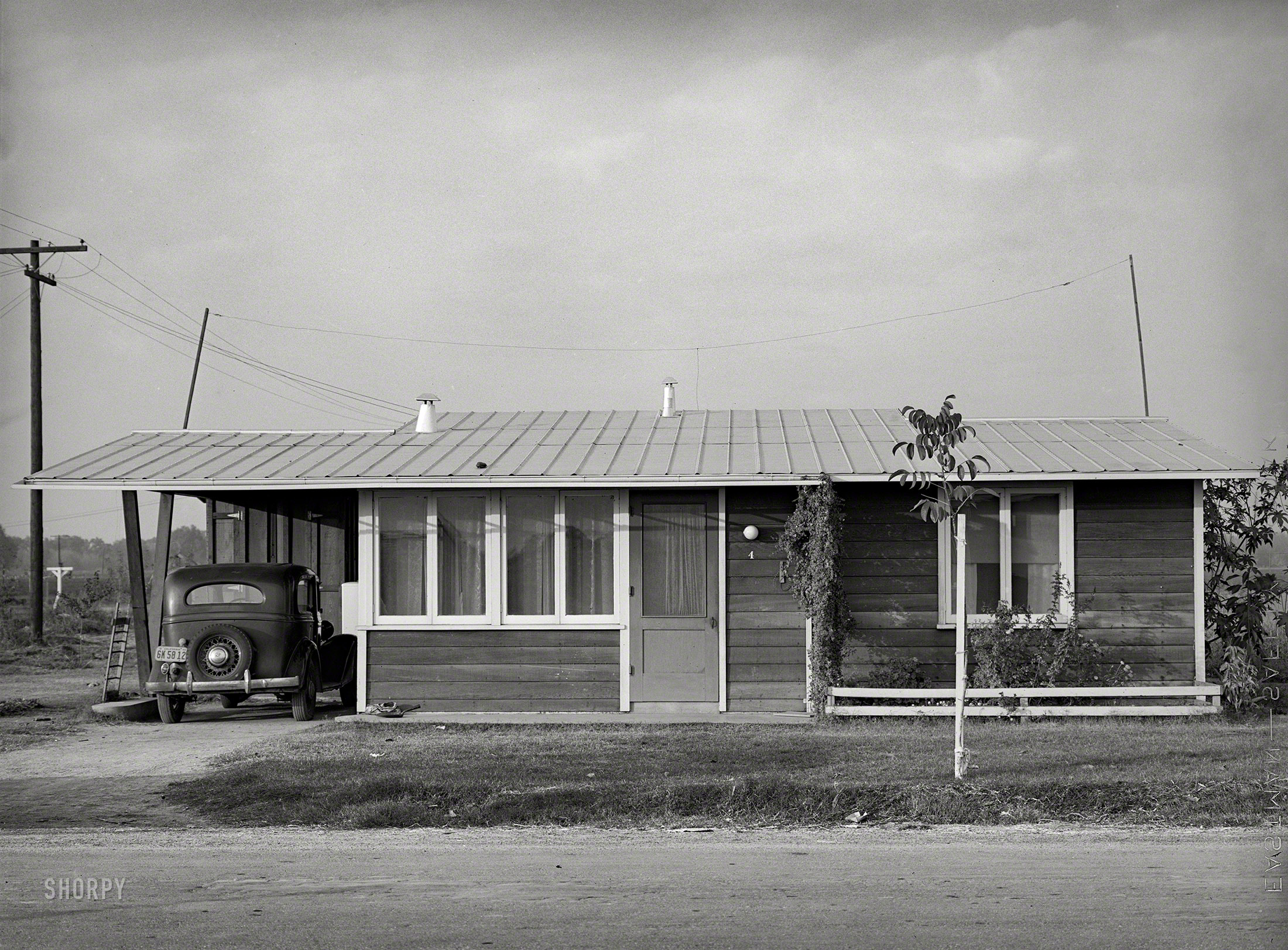 November 1940. Tulare County, California. "One of the homes at Mineral King cooperative farm, an old ranch of 500 acres raising cotton, alfalfa, and dairy products for cash crops. Ten families [including the Schmidts] have been established here by the Farm Security Administration in modern houses." Forerunner of the suburban ranch house that characterized so much postwar residential development. Medium format negative by Russell Lee. View full size.