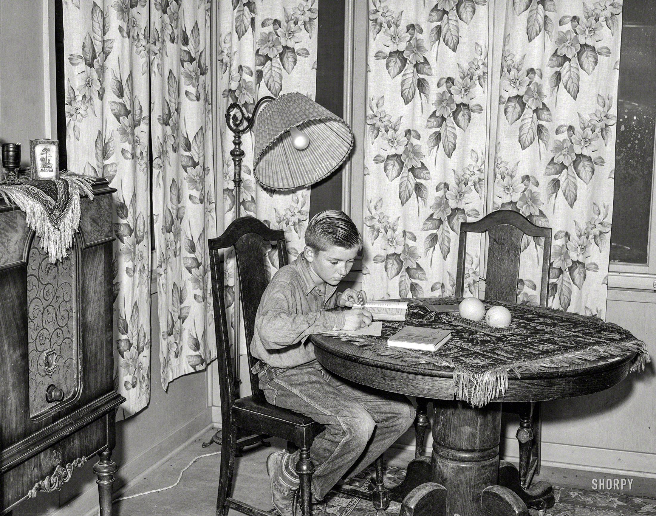 November 1940. "Son of Mr. Schmidt, member of Mineral King cooperative farm, doing his homework. Tulare County, California." Medium format negative by Russell Lee for the Farm Security Administration. View full size.