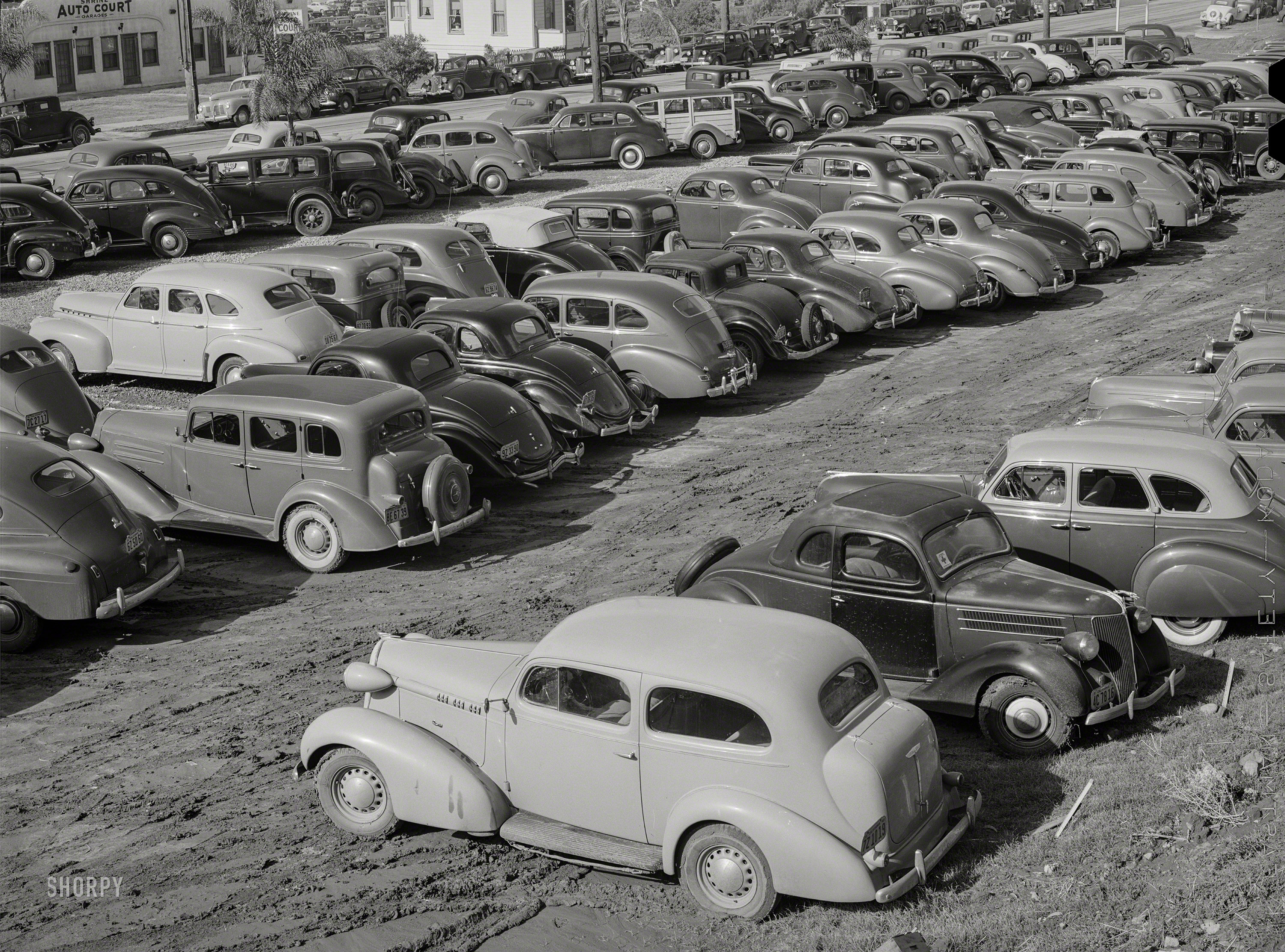 December 1940. "San Diego, California. Workers' automobiles parked near the airplane factories. Providing parking space for automobiles and getting the cars in and out at shift changing time have been big problems." Medium format acetate negative by Russell Lee for the Farm Security Administration. View full size.