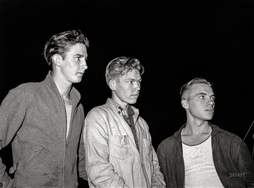 December 1940. San Diego, California. "Three boys from Los Angeles who are looking for work. A friend who is already employed told them that they could make twenty dollars a week as laborers and they plan to save some money to go to school in hopes of getting in an airplane factory. The following conversation with their friend was overheard:
"You can go to work before noon tomorrow. Just go out where you see some work and apply."
"We can sure use the money."
"It's up to you fellows, you just got to hustle."
"We done plenty of that."
Medium format negative by Russell Lee. View full size.
