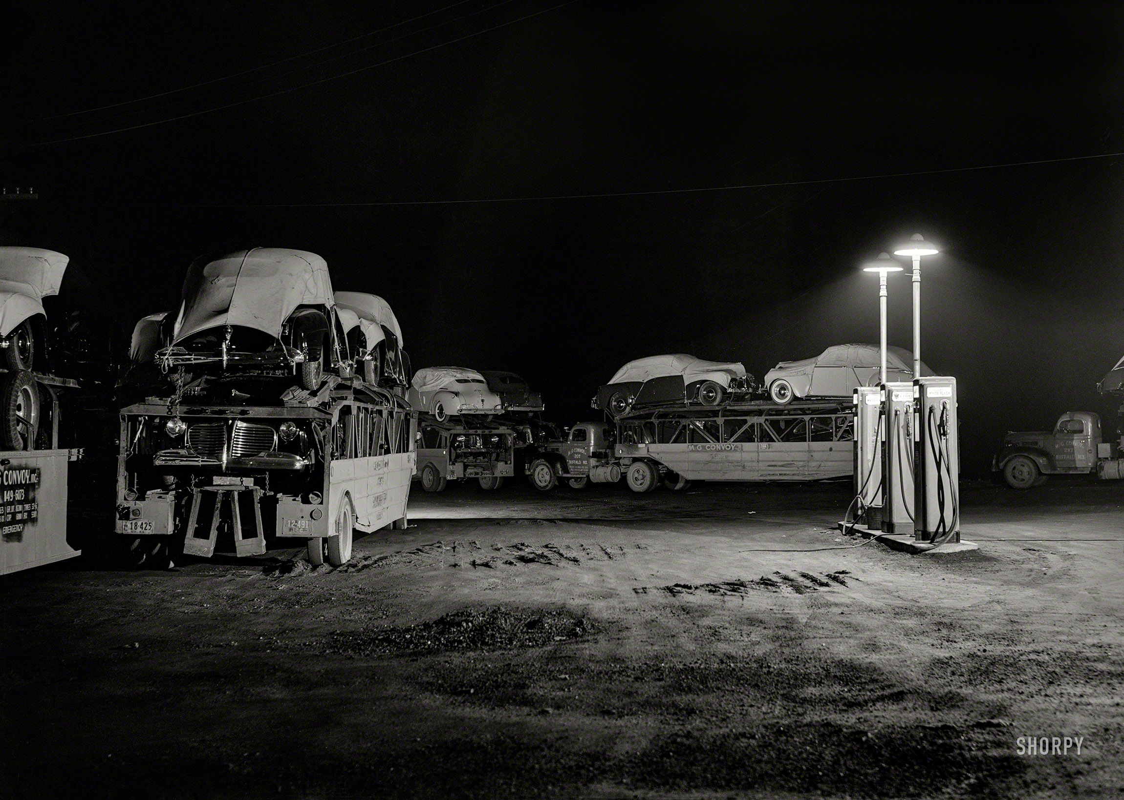 April 1941. "Auto convoy trucks at service station near Chicago." Medium format negative by Russell Lee for the Farm Security Administration. View full size.