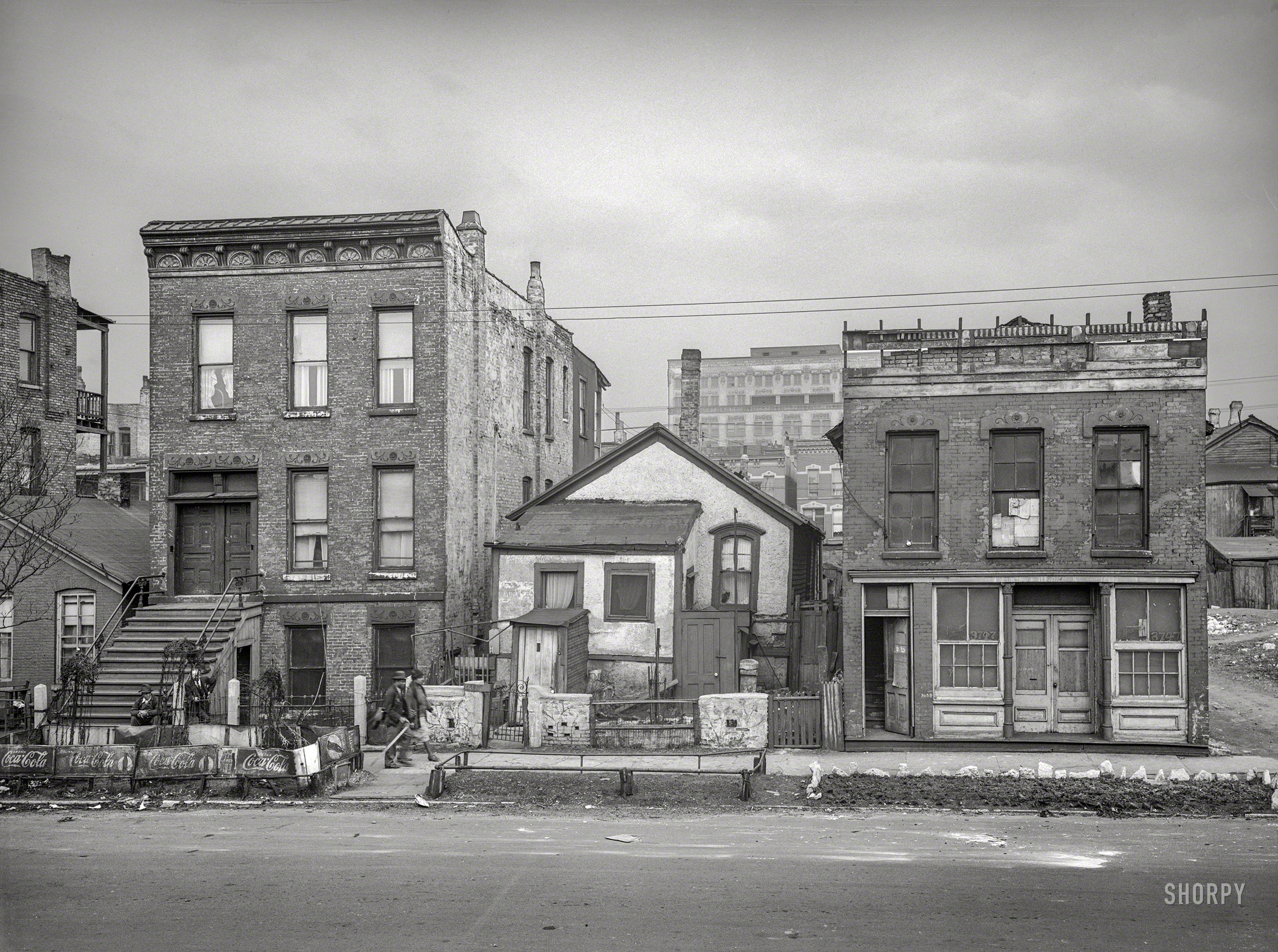April 1941. "Scene in Negro section of Chicago, Illinois." Photographer Russell Lee's exploration of the South Side enclave known as Bronzeville continues with this stop at a garden plot fenced by Coca-Cola signs. View full size.