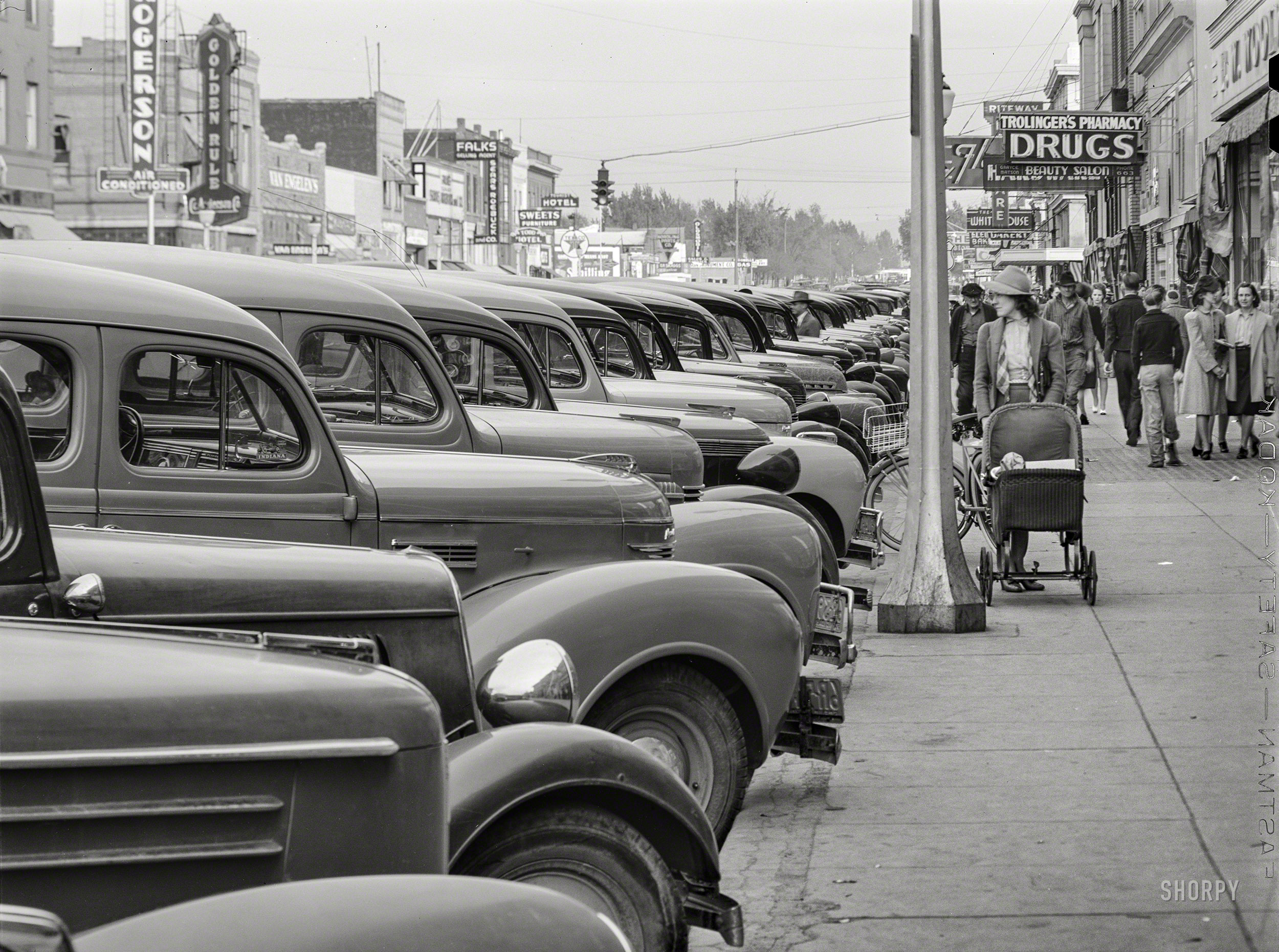 &nbsp; &nbsp; &nbsp; &nbsp; From start to finish, a life on wheels.
May 1941. "Main street of Twin Falls, Idaho. According to Idaho State Guide (Federal Writers Project), this town has the distinction, unusual in towns in the section, of being planned." Photo by Russell Lee for the FSA. View full size.