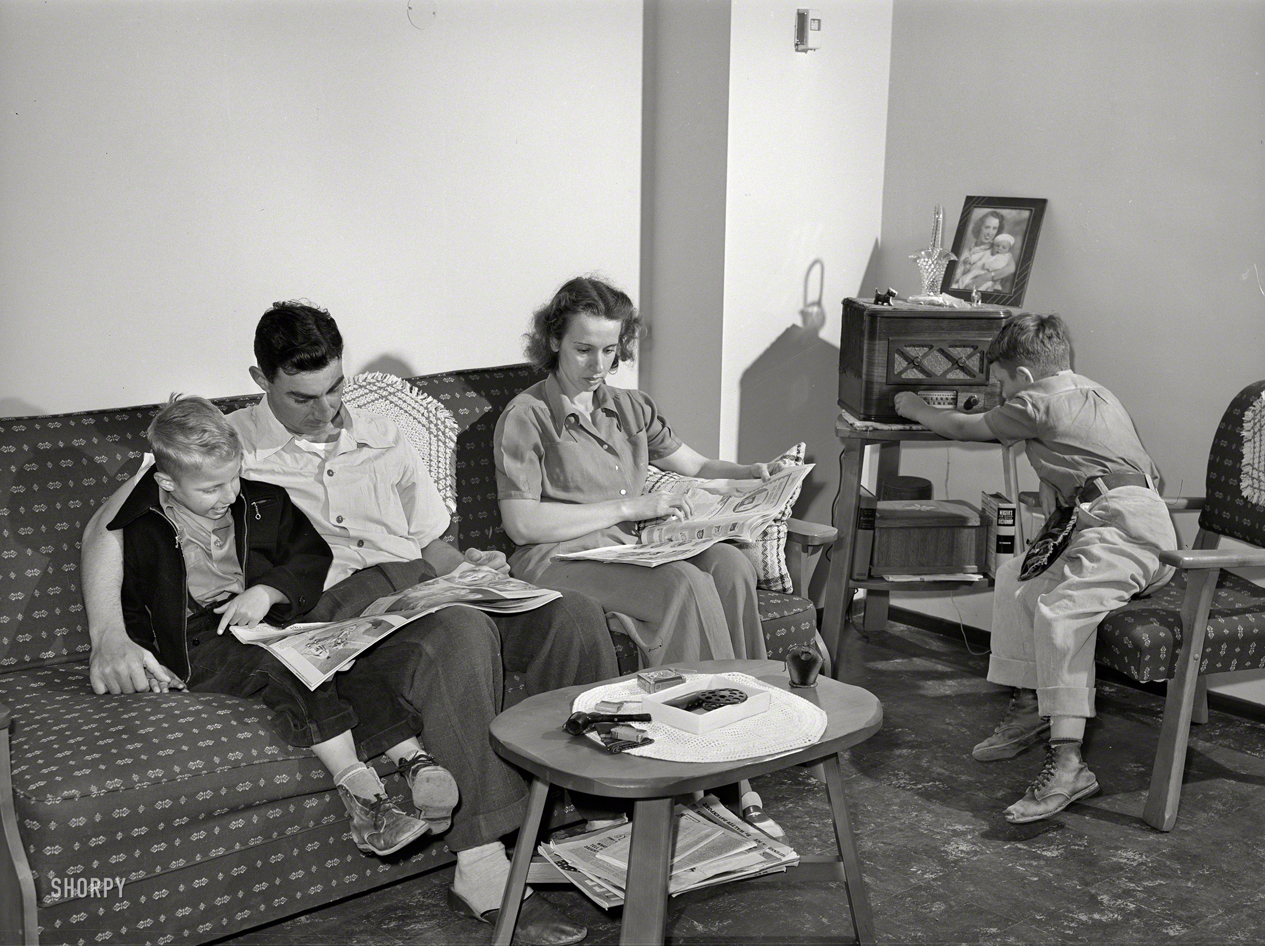 June 1941. "Family of Marine in their living room. They live in one of the units of the Navy defense housing project which is designed for Naval people, Marines and some civilian defense workers. San Diego, California." Medium format acetate negative by Russell Lee for the Farm Security Administration. View full size.