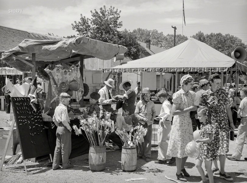 July 1941. "Carnival attractions in Vale, Oregon, on the Fourth of July." Acetate negative by Russell Lee for the Farm Security Administration. View full size.
