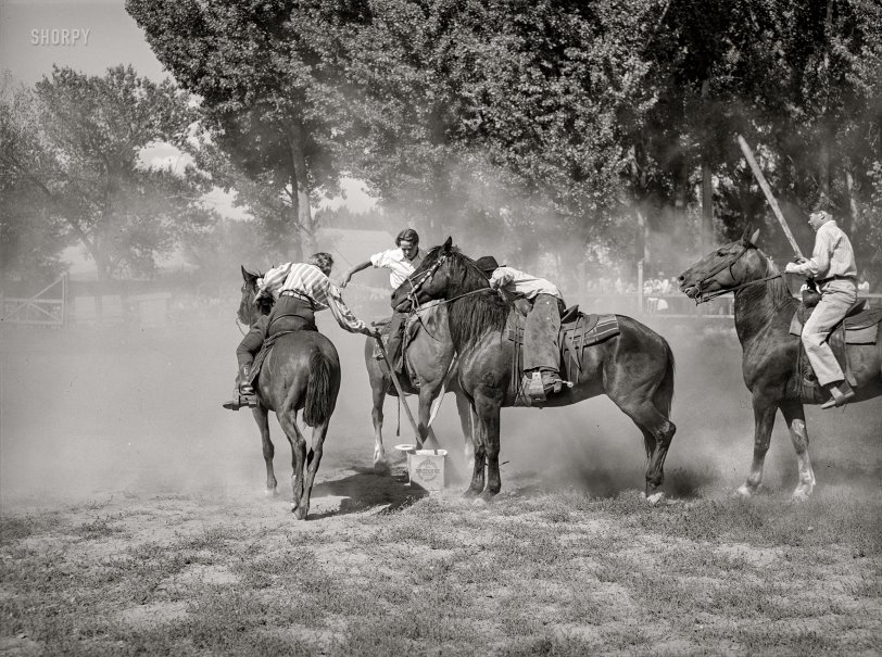 July 1941. "Getting potatoes from bucket in potato race at the Fourth of July celebration in Vale, Oregon." Photo by Russell Lee for the Farm Security Administration. View full size.

