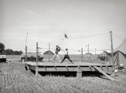 June 1941. "Transient workers. Boxing platform at FSA migratory farm labor camp mobile unit. Athena, Oregon." Medium format acetate negative by Russell Lee for the Farm Security Administration. View full size.