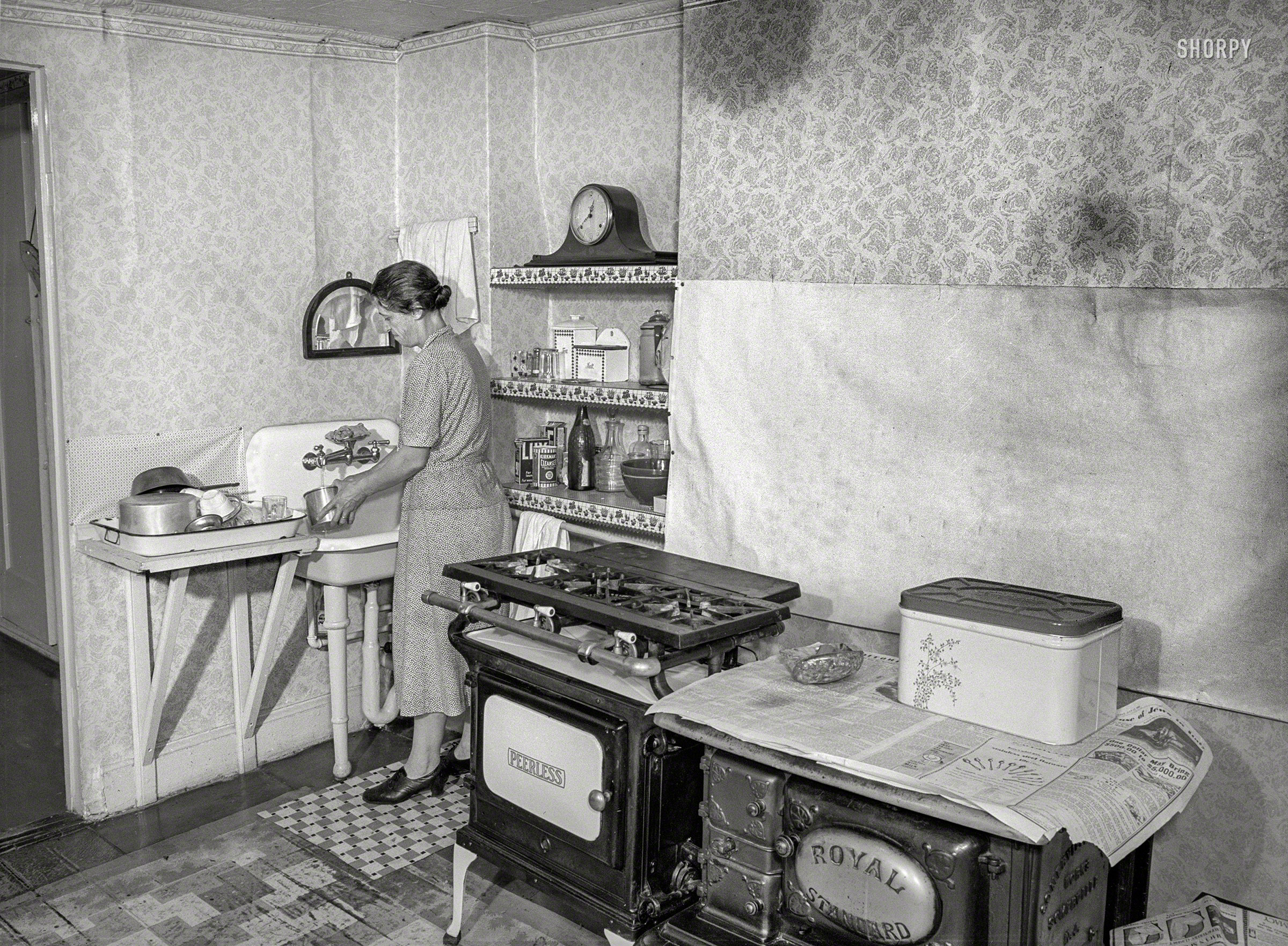 1938. "New York, New York. John Montefiori's sister-in-law in her kitchen at 340 East 63rd Street. Mr. Montefiori, tenant and janitor of the building, works in a sculpture factory that turns out the little white horses for White Horse Whisky, etc." Medium format acetate negative by Sheldon Dick. View full size.