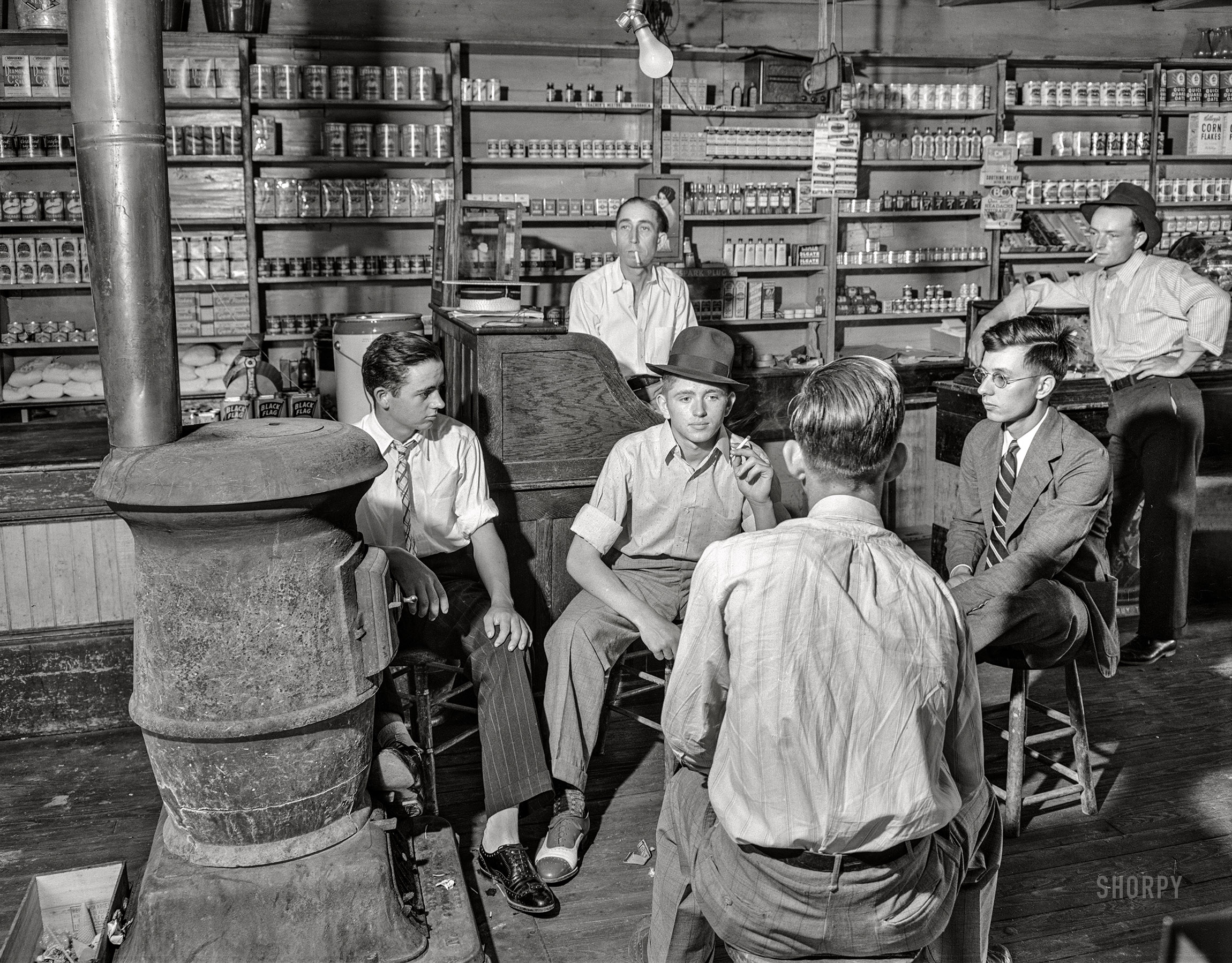 Saturday, May 25, 1940. "Interior of general store at Stem, Granville County, North Carolina, with high school boys dressed up because it's Election Day." Medium format acetate negative by Jack Delano for the Farm Security Administration. View full size.