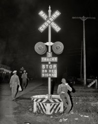 July 1940. "Negroes from Florida and Georgia who travel by car and truck, following the potato crop northward. Migratory agricultural worker has his supper (a nickel pie and a glass of milk) at the railroad crossing at Camden, North Carolina." Medium format acetate negative by Jack Delano for the Farm Security Administration. View full size.
