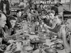 October 1940. "Lunch hour at one of the farms of the Woodman Potato Co. All of the pickers and field laborers eat in this converted tool house, 11 miles north of Caribou, Maine." Acetate negative by Jack Delano for the FSA. View full size.