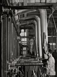 October 1940. East Hartford, Connecticut. "New type of plating machine being used at the Hamilton Standard Propeller Corporation. It automatically dips the part into the proper solutions for the proper length of time." Acetate negative by Jack Delano. View full size.