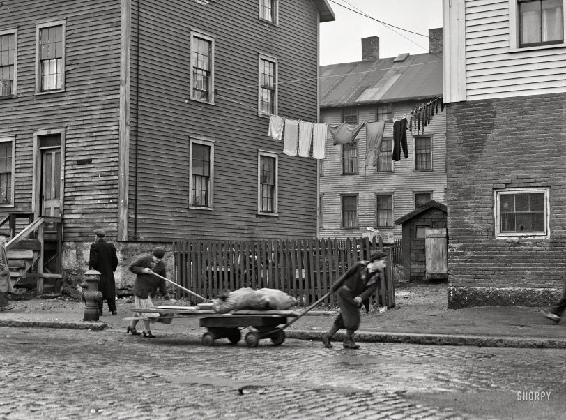 January 1941. New Bedford, Massachusetts. "Bringing home some salvaged firewood in a slum area." Photo by Jack Delano. View full size.
