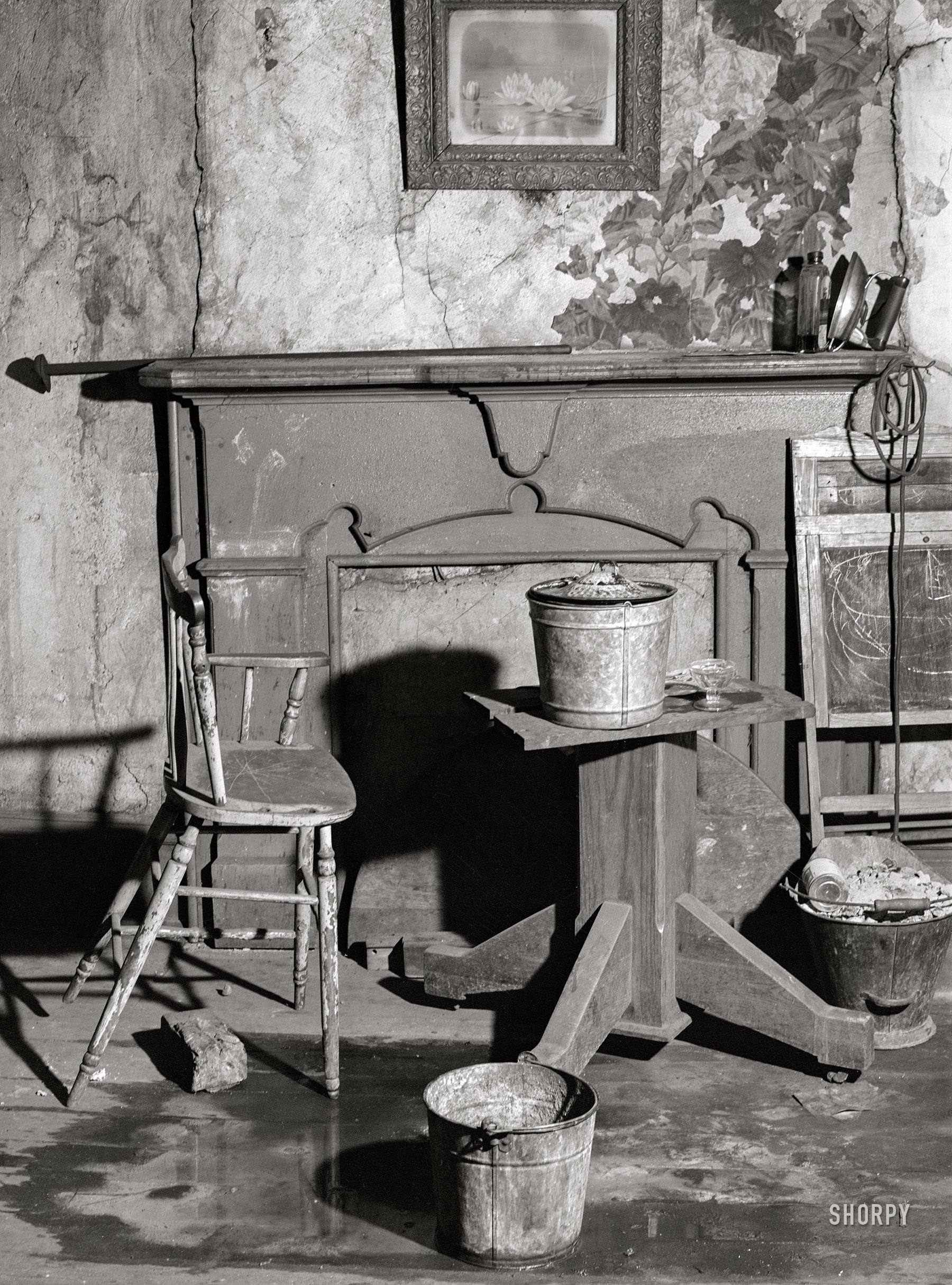 January 1940. "Buckets placed in room to catch water from leaky ceiling in a house in Mount Washington district. Beaver Falls, Pennsylvania." Photo by Jack Delano. View full size.