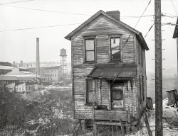 January 1941. "One of the houses in the Negro quarter of Rochester, Pennsylvania. Abandoned glass works in background." Medium format negative by Jack Delano for the Farm Security Administration. View full size.