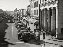 March 1941. "Traffic on the main street of Fayetteville, North Carolina at about five o'clock, when the workers start coming out at Fort Bragg." Medium format negative by Jack Delano for the Farm Security Administration. View full size.