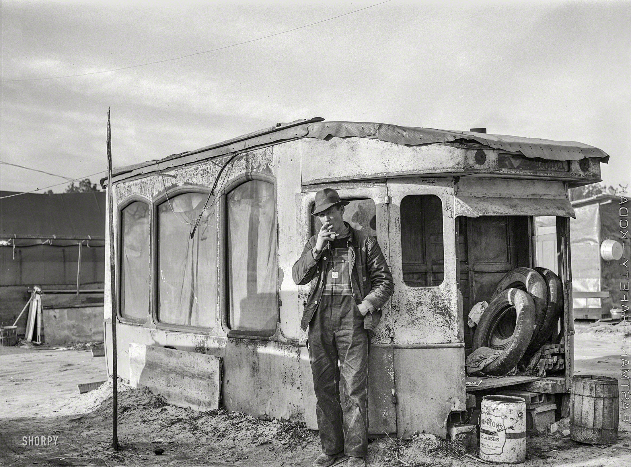 March 1941. "Construction worker from Fort Bragg. He lives in this homemade bunkhouse in Manchester, North Carolina." Medium format acetate negative by Jack Delano for the Farm Security Administration. View full size.