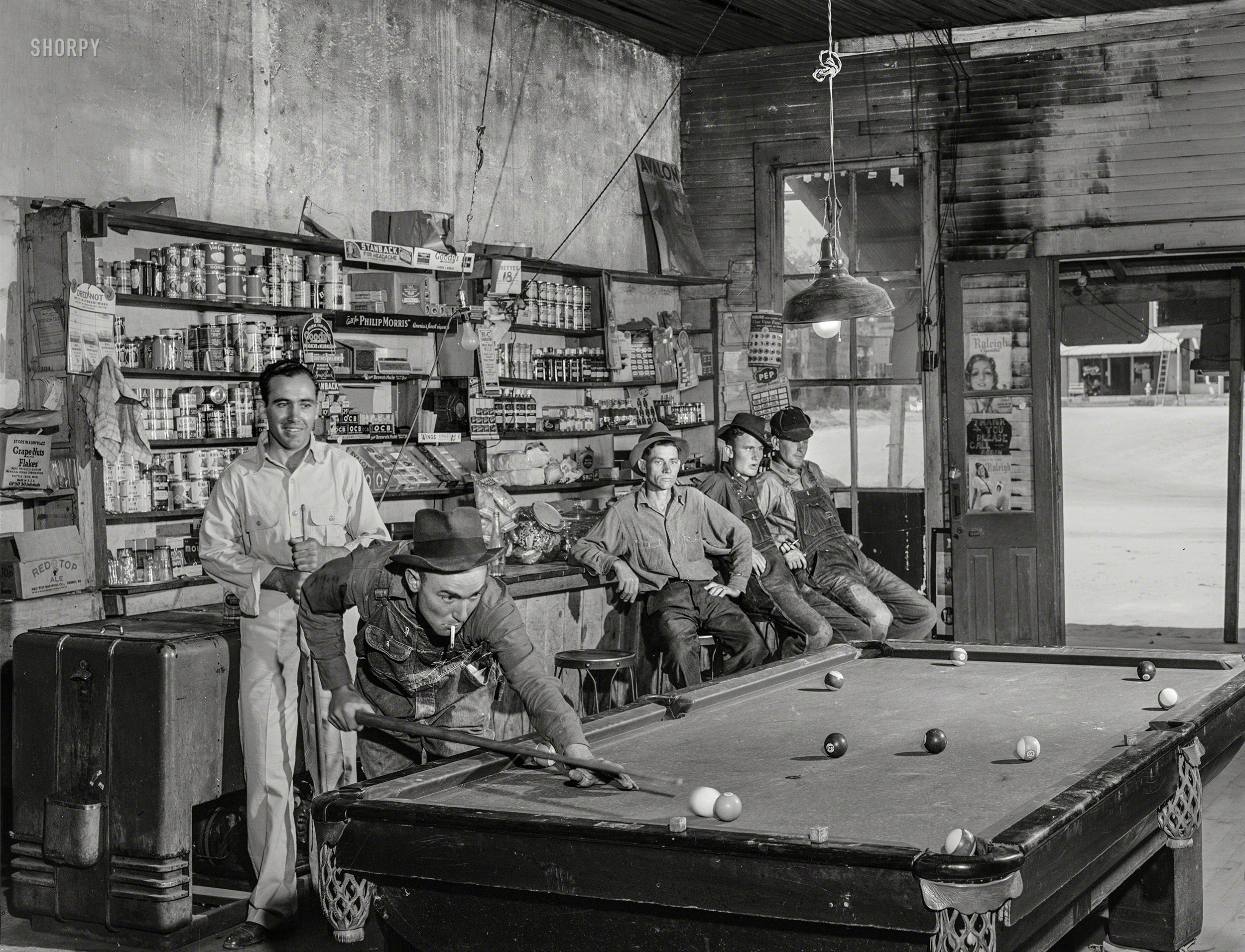 April 1941. "A game of pool in the general store. Franklin, Heard County, Georgia." The contest last seen here. Acetate negative by Jack Delano. View full size.