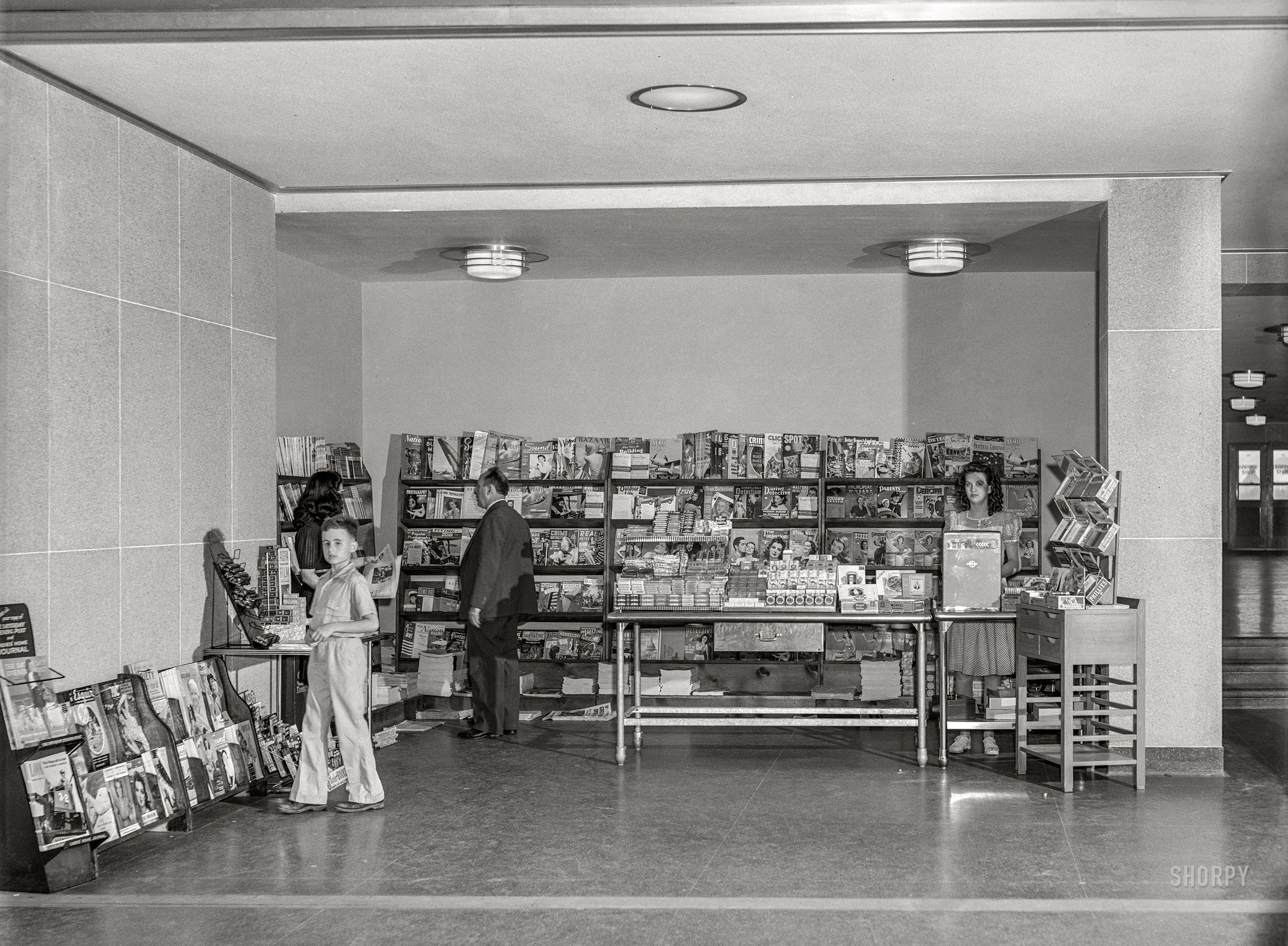 July 1941. "The newsstand in the waiting room. National Airport near Washington, D.C." Acetate negative by Jack Delano for the Farm Security Administration. View full size.