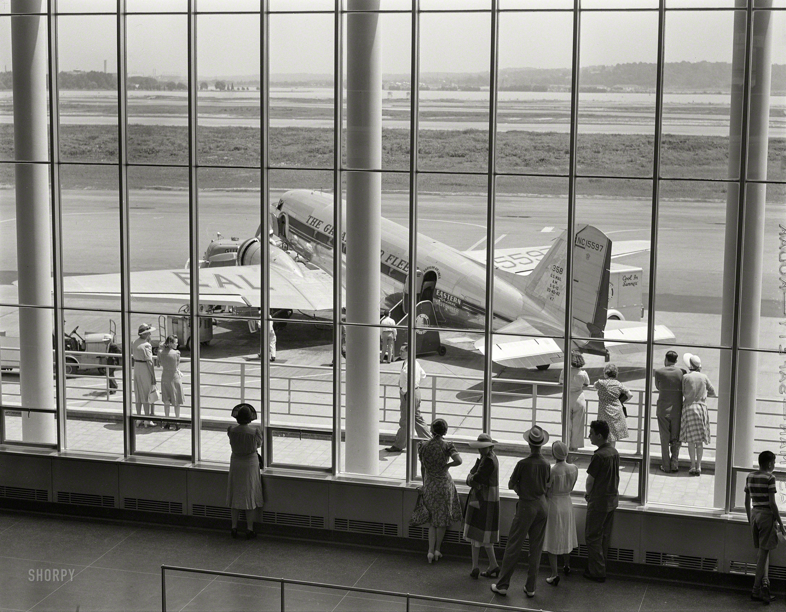 July 1941. "Observation deck and airliner on the field seen through the window of the waiting room. Municipal (National) airport, Washington, D.C." Medium format acetate negative by Jack Delano. View full size.
