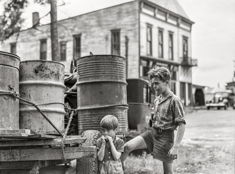 August 1941. "Pine Camp military area, near Watertown, N.Y. Removal of farm families and relocation in new sections with the aid of the New York Defense Relocation Corporation. Two of the children of Mr. Earl J. Brown helping to get the last few belongings out of their farm in the Pine Camp expansion area." Medium format acetate negative by Jack Delano. View full size.

