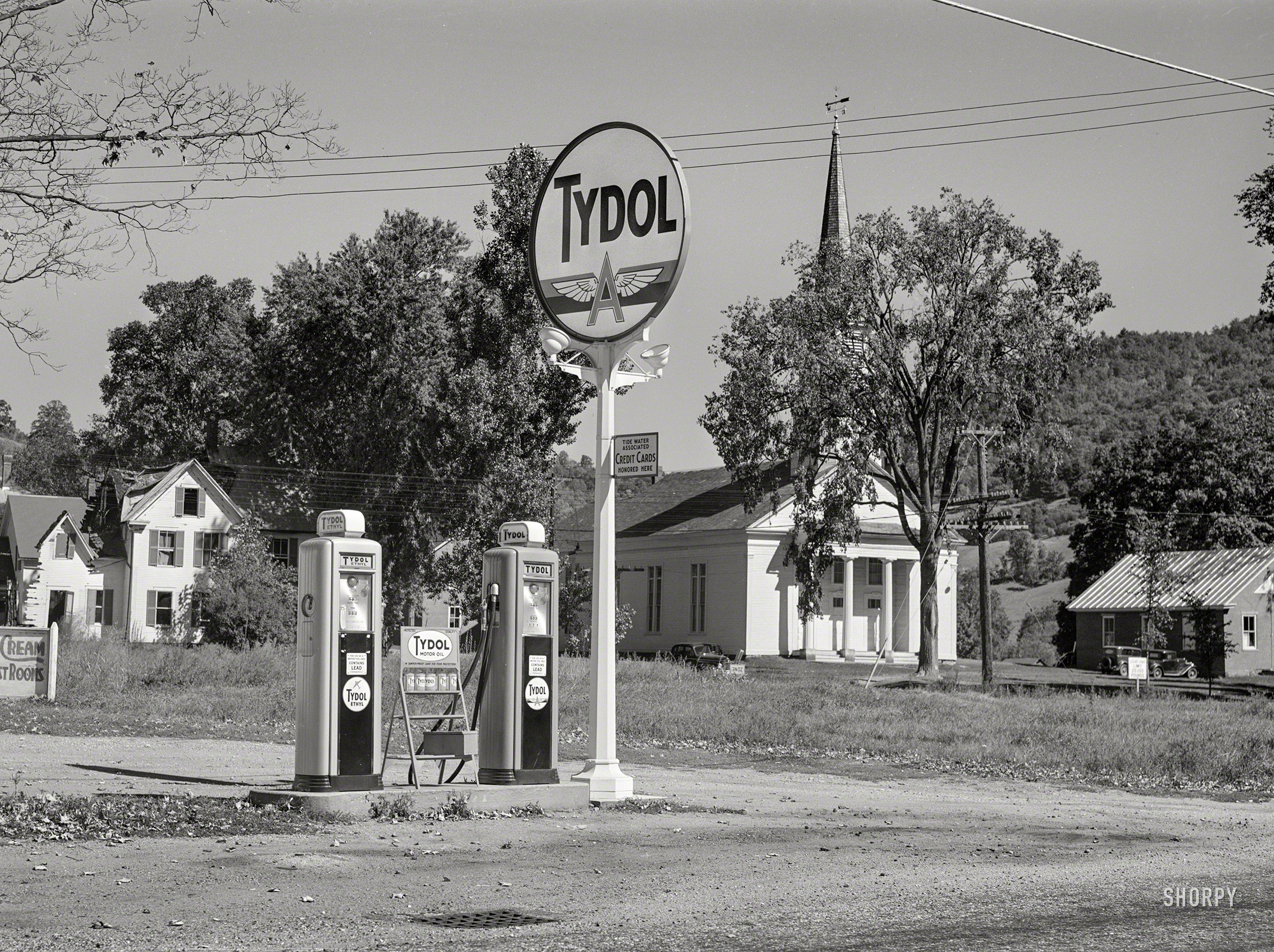 &nbsp; &nbsp; &nbsp; &nbsp; UPDATE: Our location, as pinpointed by commenter Silliaek, is Route 14 in Sharon, Vermont.
September 1941. From somewhere in Vermont comes this uncaptioned snap by Jack Delano, who was so smitten by this view of gas pumps and a church that he shot it twice. Medium format acetate negative. View full size.
