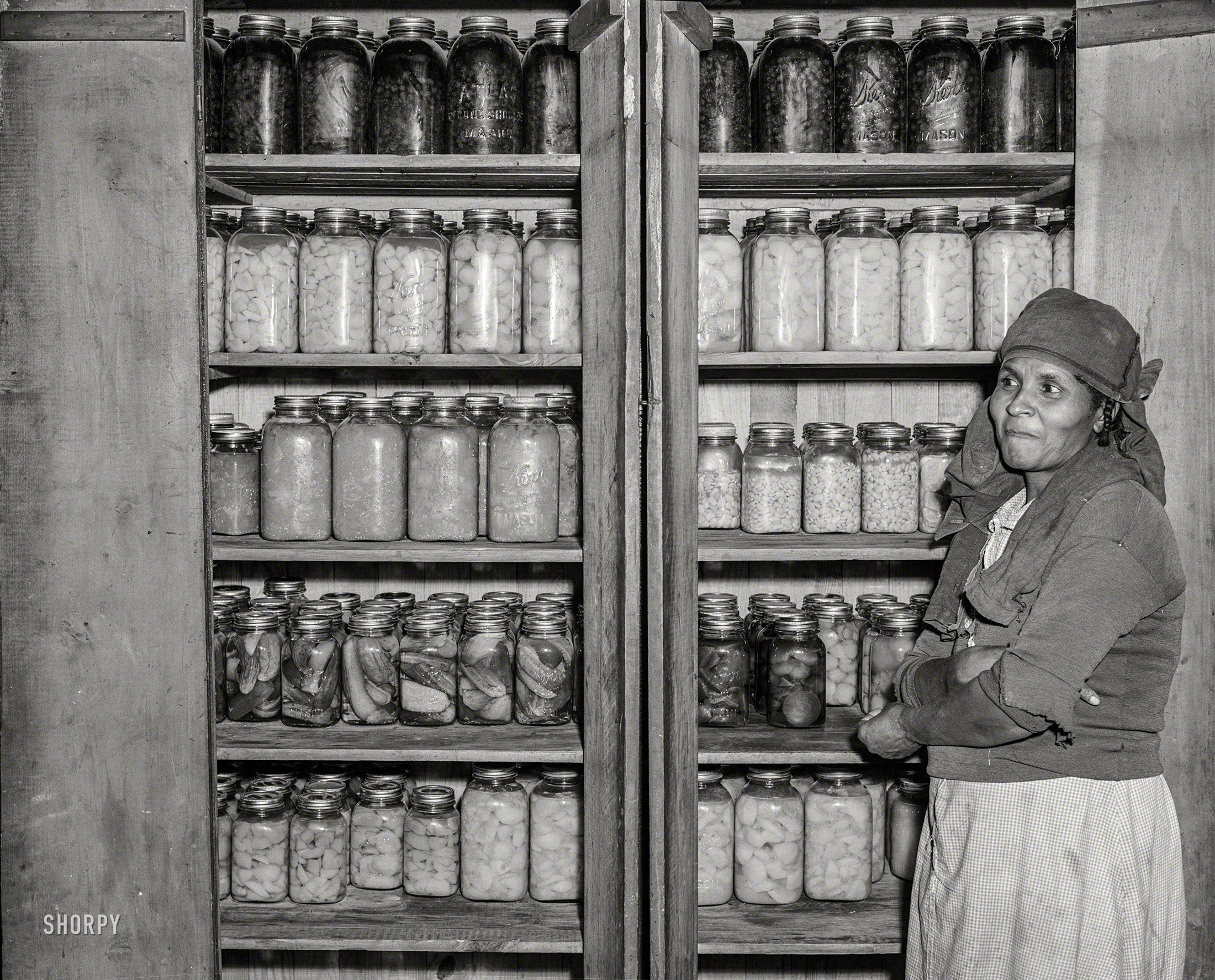 November 1941. "Mrs. Buck Grant, Farm Security Administration client, with her canned goods. Near Woodville, Georgia." Photo by Jack Delano. View full size.
