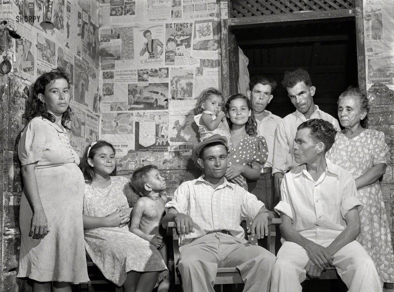 January 1942. "Guayanilla, Puerto Rico. Family of a sugar worker living in one of the company houses behind the mill. All these people live in the same house." Medium format negative by Jack Delano. View full size.
