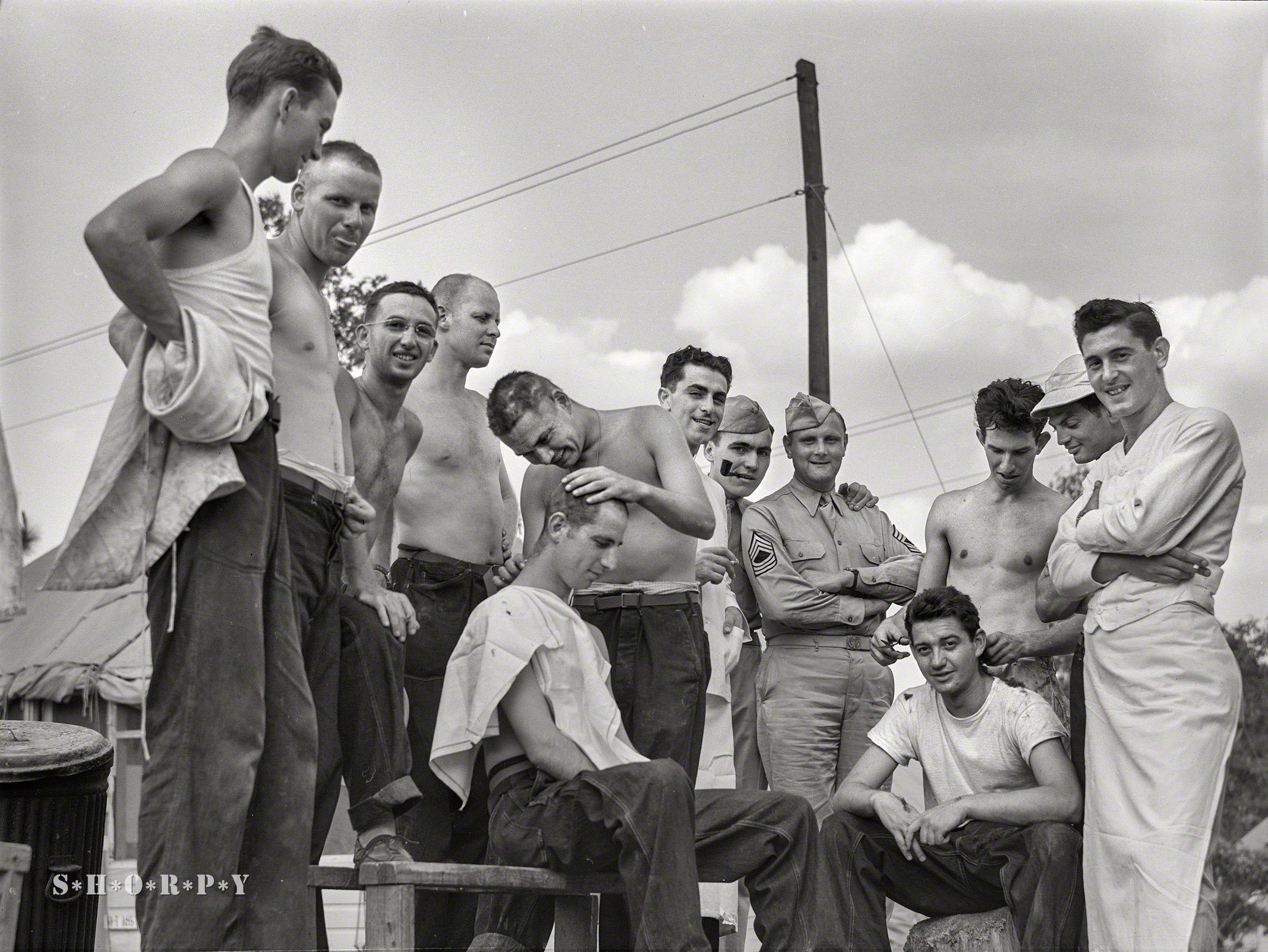 June 1941. "Hattiesburg, Mississippi. Getting a haircut at Camp Shelby." Medium format acetate negative by William Perlitch. View full size.