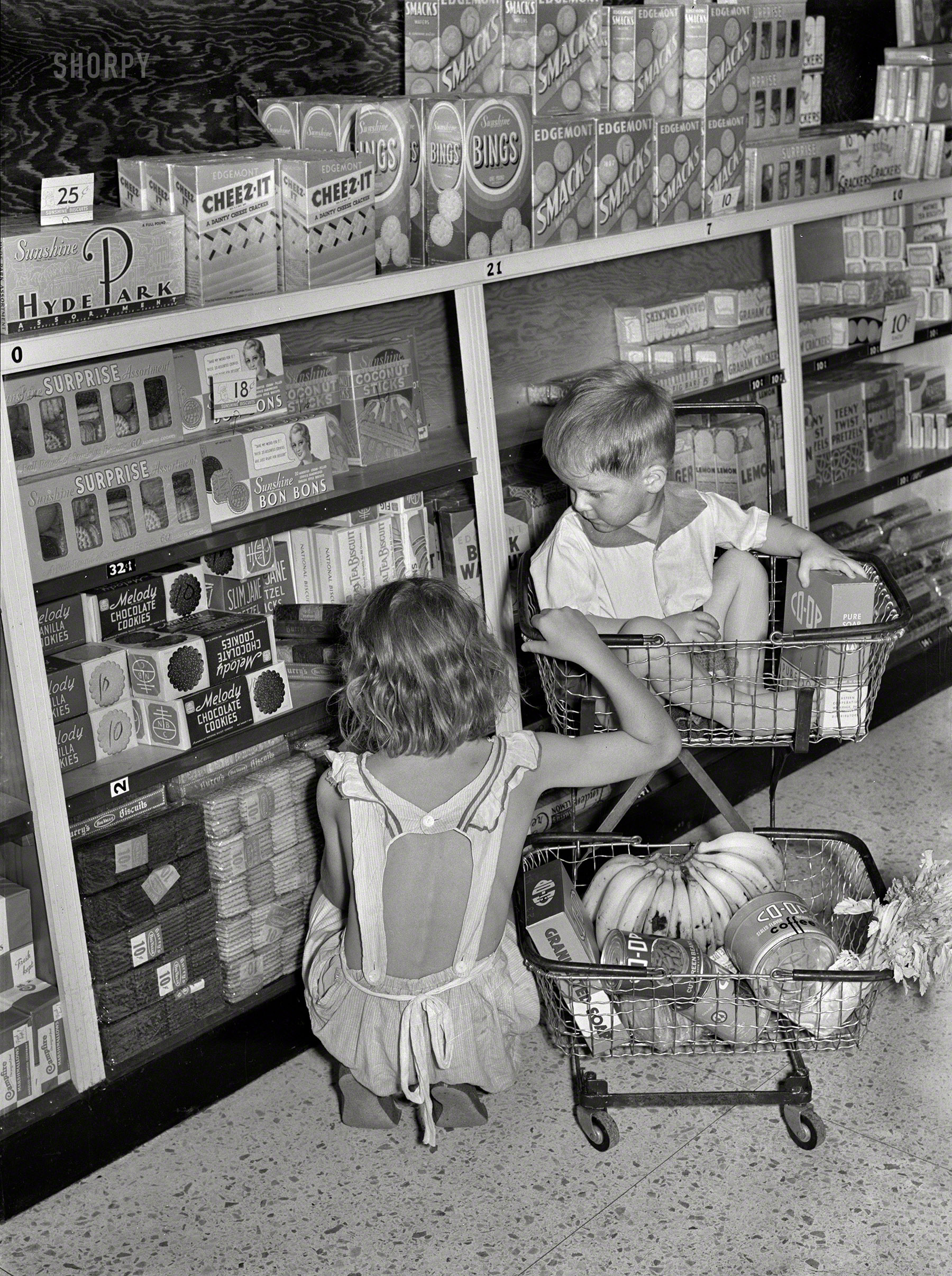September 1938. "Children buying groceries in co-op store. Greenbelt, Maryland." Medium format negative by Marion Post Woolcott. View full size.