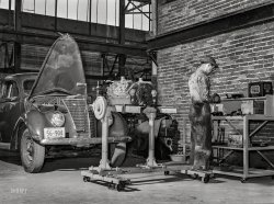 May 1939. "Repairing automobile motor at the FSA warehouse depot in Atlanta, Georgia." Acetate negative by Marion Post Wolcott for the Farm Security Administration. View full size.