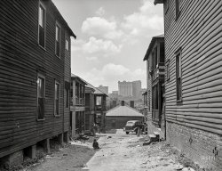 May 1939. "Slums in Negro district. Atlanta, Georgia." Medium format negative by Marion Post Wolcott for the Farm Security Administration. View full size.