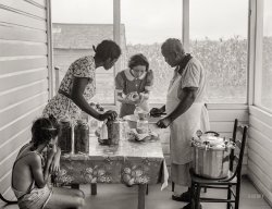 June 1939. Summerton, South Carolina. "FSA home supervisor assisting wife and daughter of Frederick Oliver, tenant purchase client, in canning with new pressure cooker." Medium format negative by Marion Post Wolcott for the Farm Security Administration. View full size.