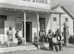 November 1939. "Negroes cut each other's hair in front of plantation store after being paid off on Saturday. Mileston Plantation, Mississippi Delta." Medium format acetate negative by Marion Post Wolcott for the Farm Security Administration. View full size.