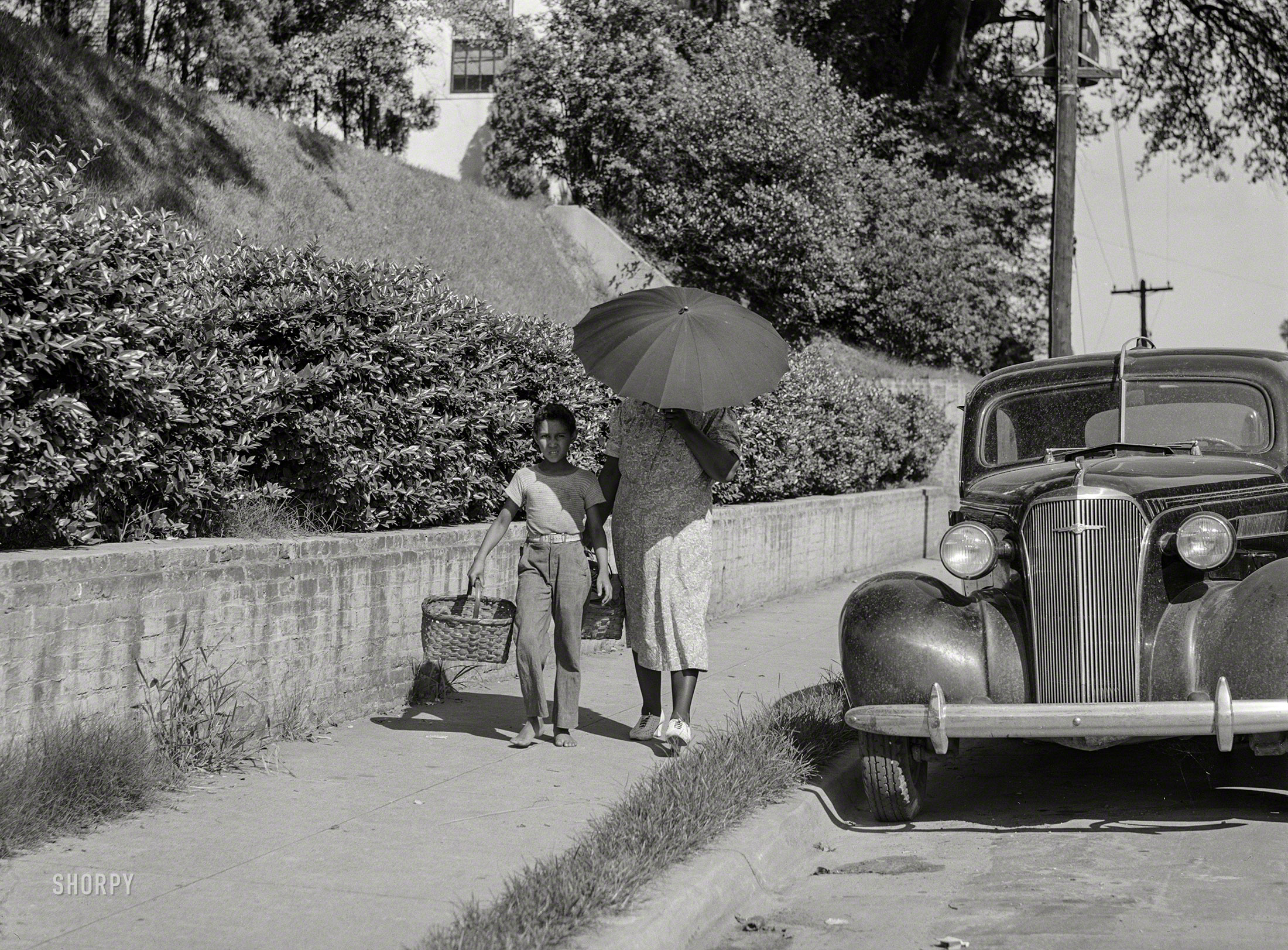 August 1940. "Street scene in Natchez, Mississippi." Medium format acetate negative by Marion Post Wolcott for the Farm Security Administration. View full size.