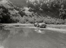 September 1940. "Car fording creek up Morris Fork of the Kentucky River." Actually oldsmobil&shy;ing the creek, in this shot of intrepid photographer Marion Post Wolcott. View full size.