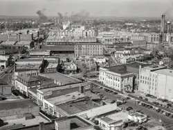October 1940. "Durham, North Carolina. Five Points, center of city, with Chesterfield cigarette factories in background." Acetate negative by Marion Post Wolcott. View full size.