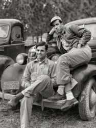 December 1940. "Camp Livingston, Alexandria, Louisiana. Construction workers from Monroe sitting on car in front of their shacks before leaving for evening shift." Medium format negative by Marion Post Wolcott for the Farm Security Administration. View full size.