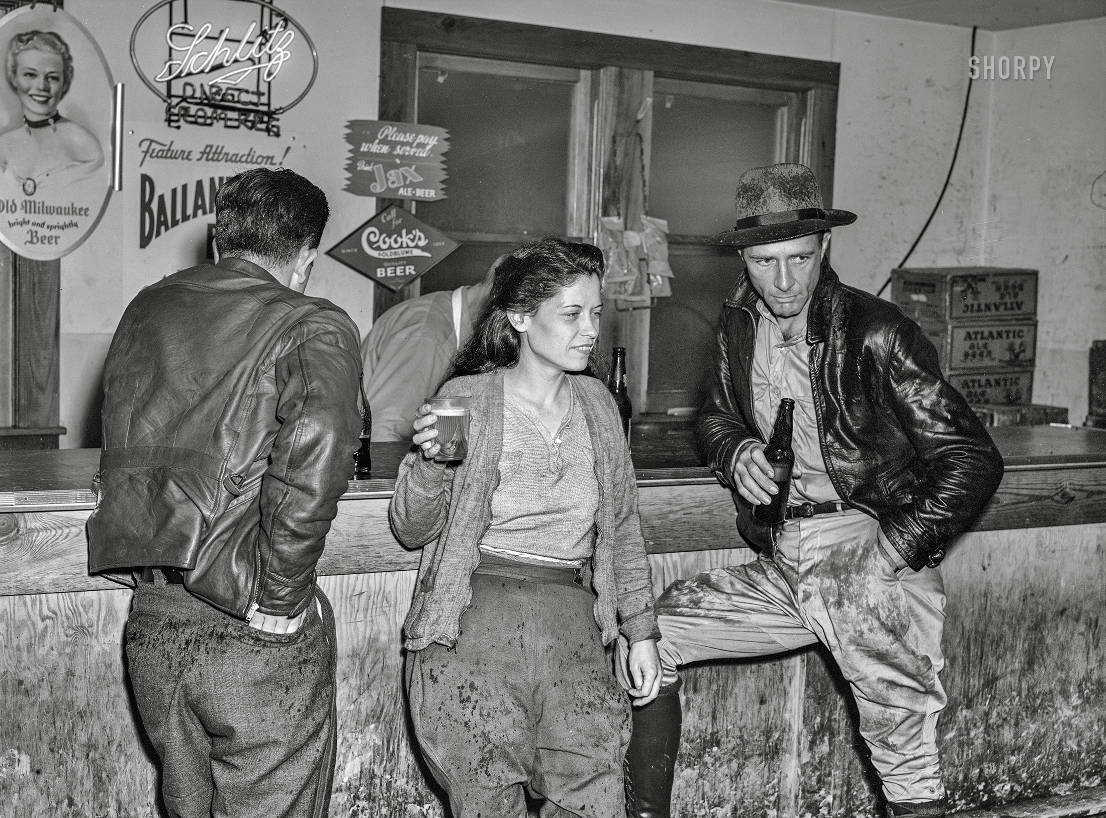 December 1940. Starke, Florida. "Construction workers drinking beer in Soldiers Joy Cafe near Camp Blanding." Medium format acetate negative by Marion Post Wolcott. View full size.