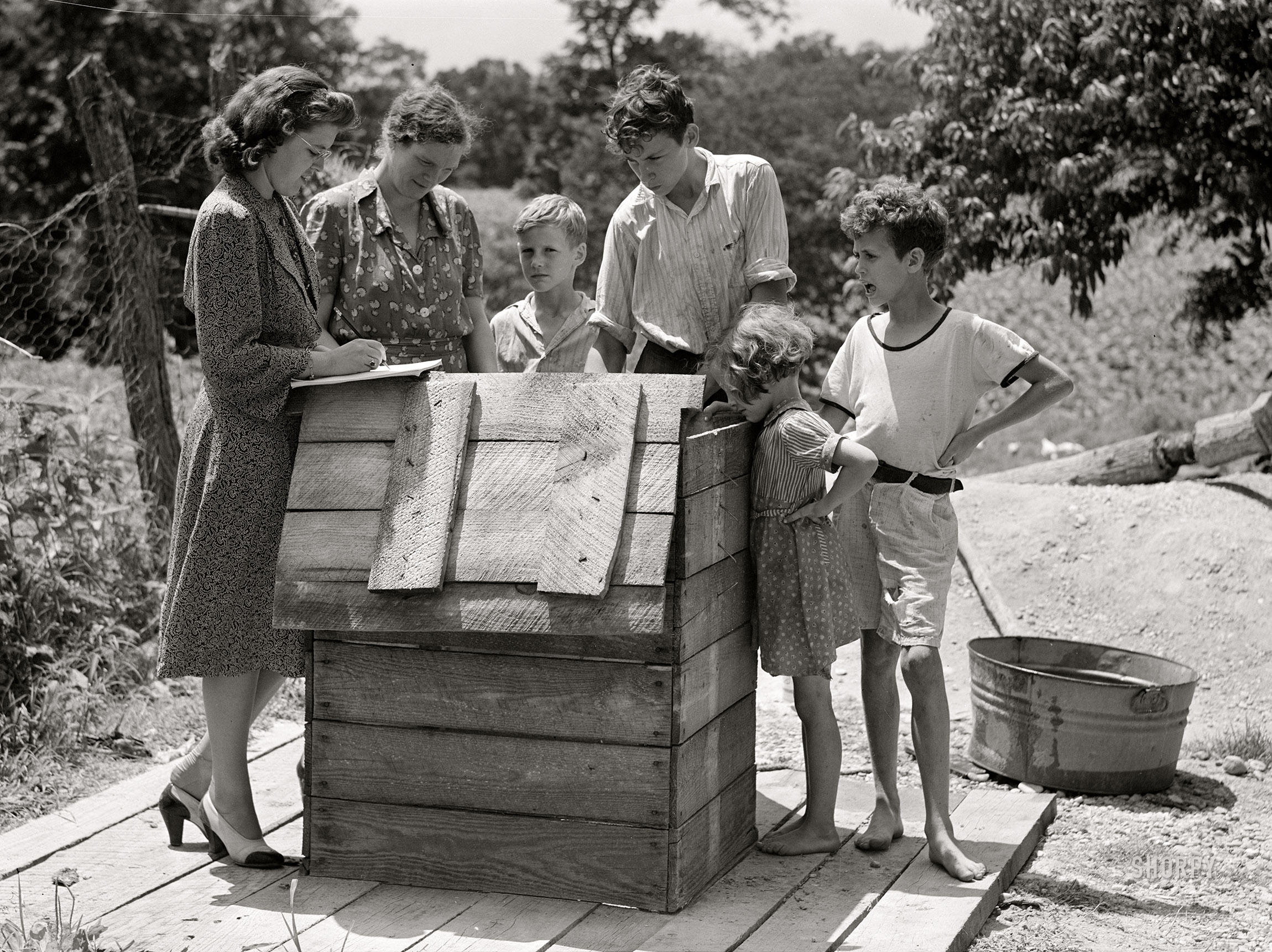 July 1941. "Home supervisor, while making home visit to FSA borrower, inspects water supply for repair. Charles County near La Plata, Maryland." Medium format acetate negative by Marion Post Wolcott for the Farm Security Administration. View full size.
