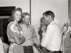 August 1941. "Dude girl with two cowboys at a Saturday night dance in Birney, Montana." Medium format acetate negative by Marion Post Wolcott. View full size.