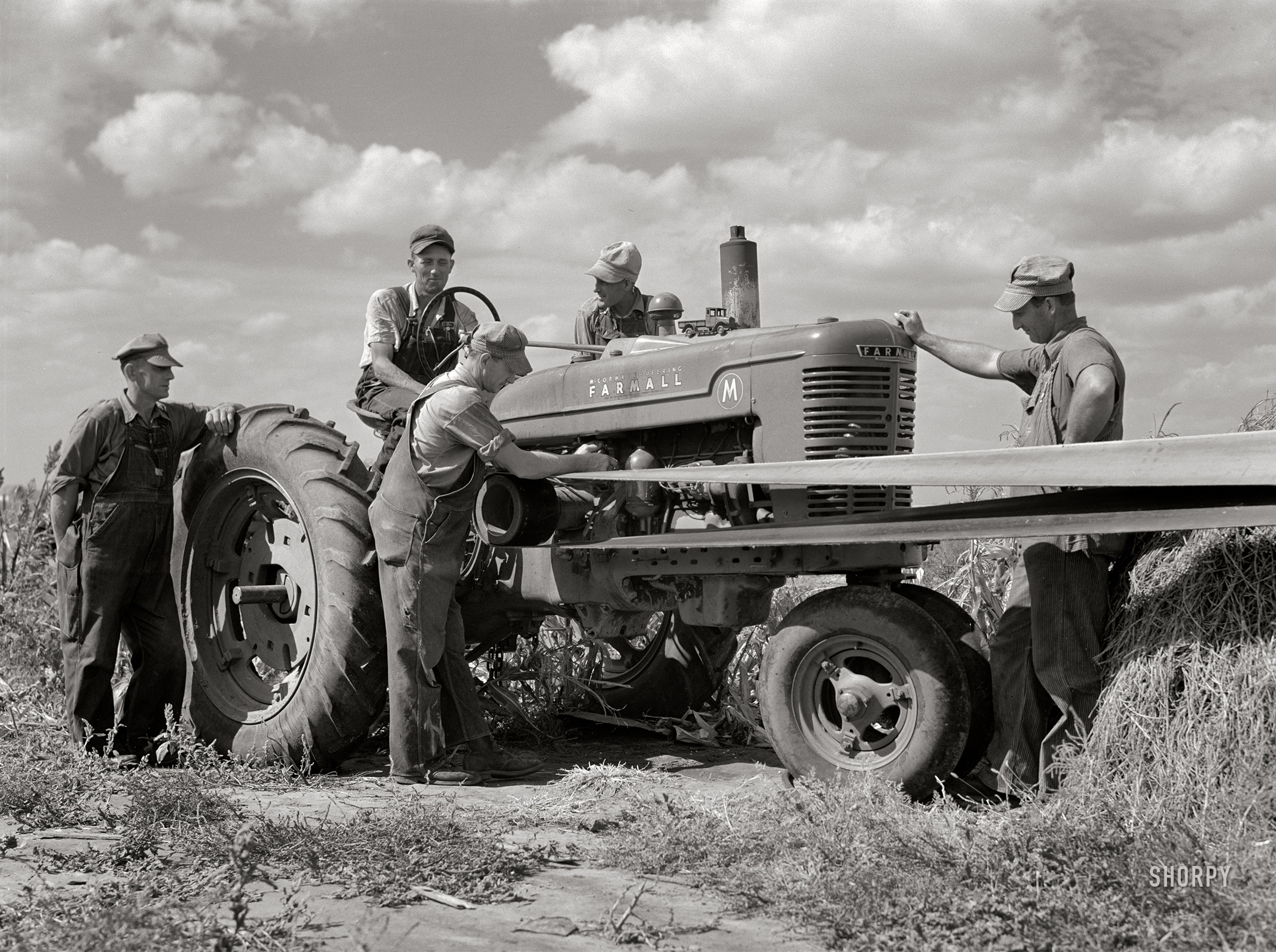 September 1941. Waterloo, Nebraska. "George Leaver, president; Don Shinaut, treasurer; Russell Smith, director; Henry Wollen and Jay Rowell, board of directors of Two River (FSA) Non-Stock Cooperative, looking at demonstration of Farmall 'M' tractor." Medium format acetate negative by Marion Post Wolcott for the Farm Security Administration. View full size.