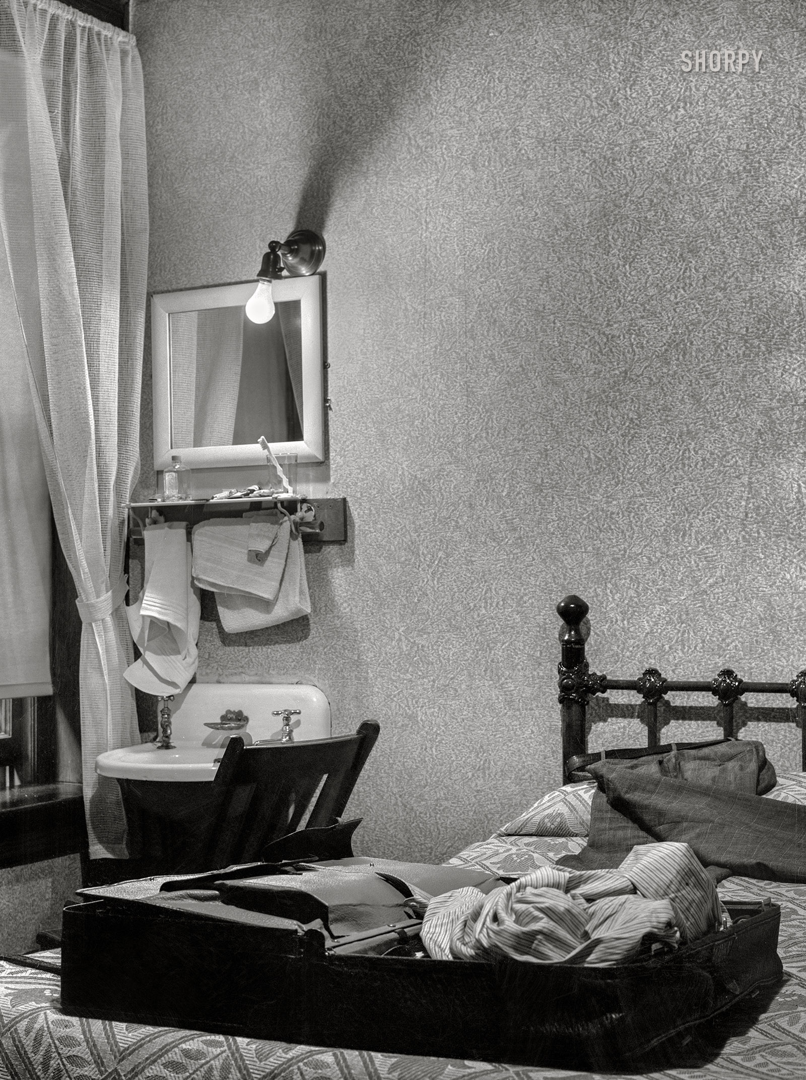 June 1939. "Hotel bedroom. Elkins, West Virginia." The Bare Bulb Arms hopes you enjoy your stay in the Edward Hopper Suite. Acetate negative by John Vachon. View full size.