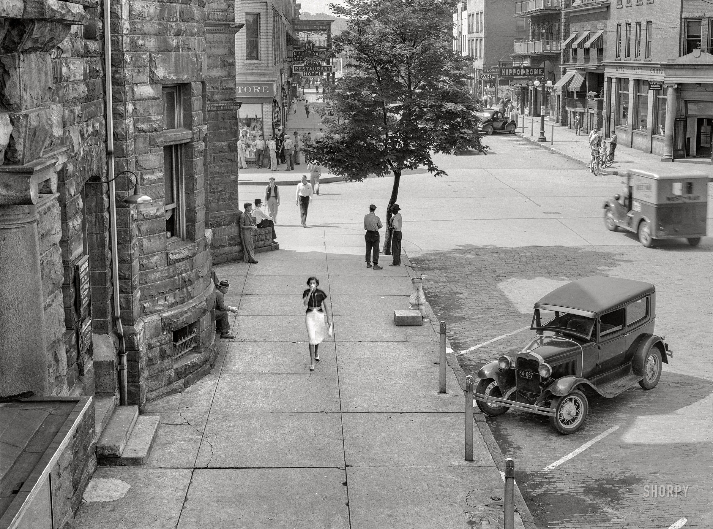 June 1939. "Shady side of main street. Elkins, West Virginia." Medium format acetate negative by John Vachon for the Resettlement Administration. View full size.
