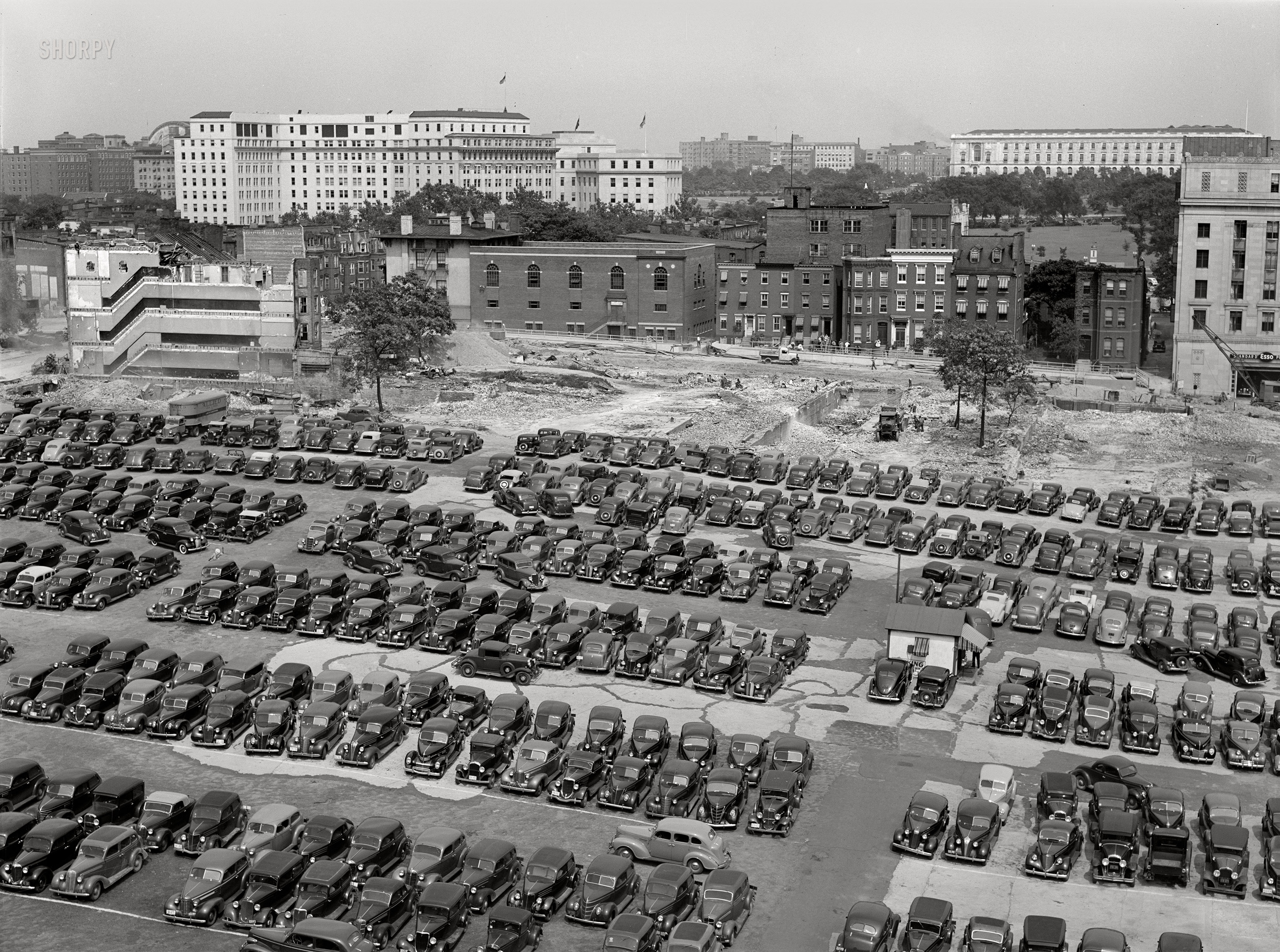 July 1939. Washington, D.C. "Parking lot for government employees, and buildings being torn down to make room for parking lot." Medium format negative by John Vachon. View full size.