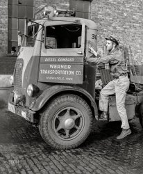 September 1939. "Driver entering cab of truck which has just been cleaned and checked over in garage preparatory to next trip. Minneapolis, Minnesota." Medium format acetate negative by John Vachon for the Farm Security Administration. View full size.