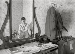 April 1940. A hotel room in Dubuque is the setting for this untitled self-portrait of photographer John Vachon. Medium format acetate negative. View full size.