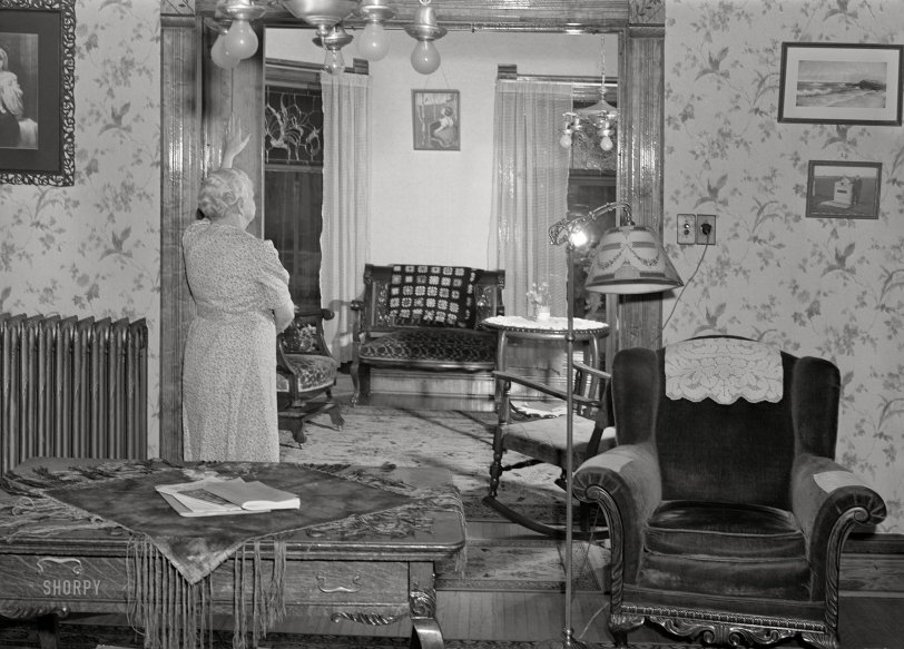 April 1940. "Home in Scranton, Iowa. Closing sliding door to little-used parlor." Medium format acetate negative by John Vachon for the Resettlement Administration. View full size.
