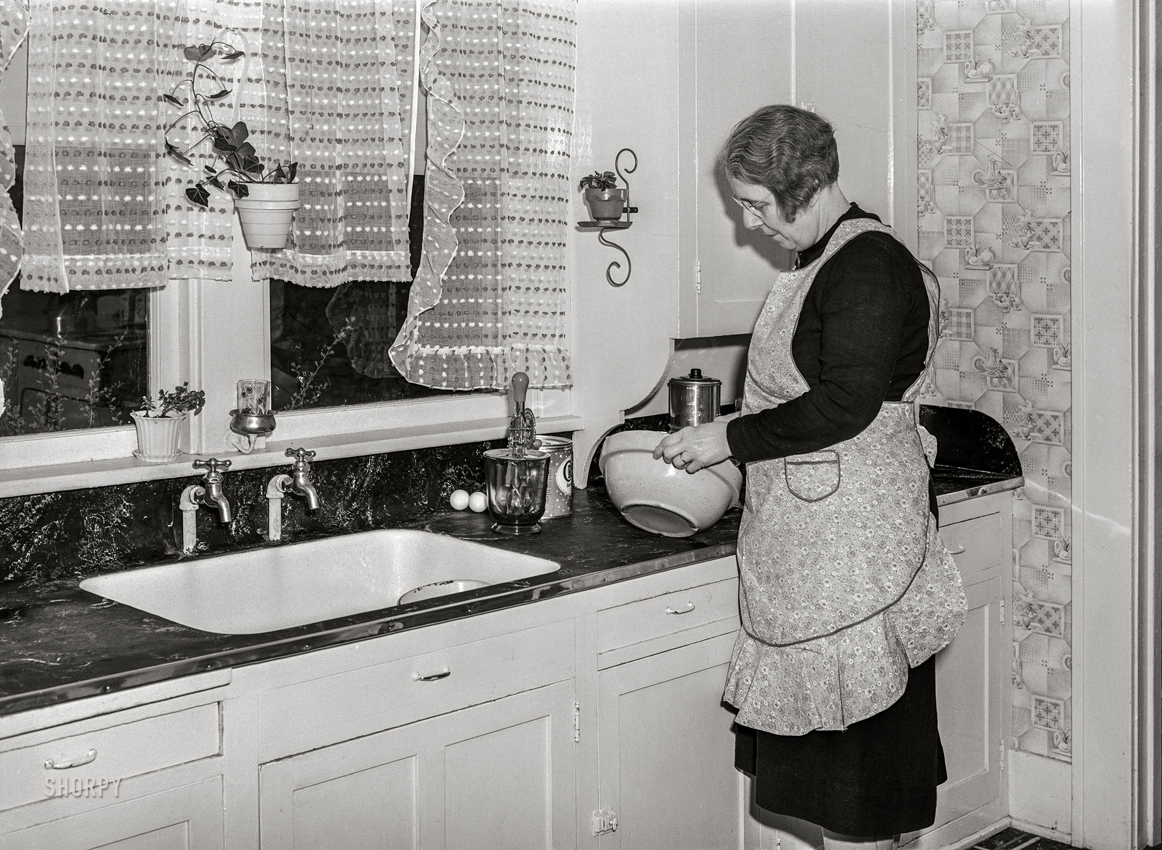 April 1940. "Wife of Iowa farmer starting to make a cake. Greene County, Iowa." Medium format acetate negative by John Vachon for the Farm Security Administration. View full size.