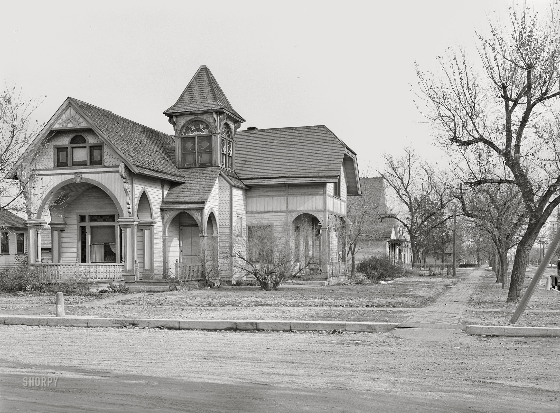 November 1940. "House in Kearney, Nebraska." A sort of hitching-post graveyard. Medium format acetate negative by John Vachon for the Farm Security Administration. View full size.
